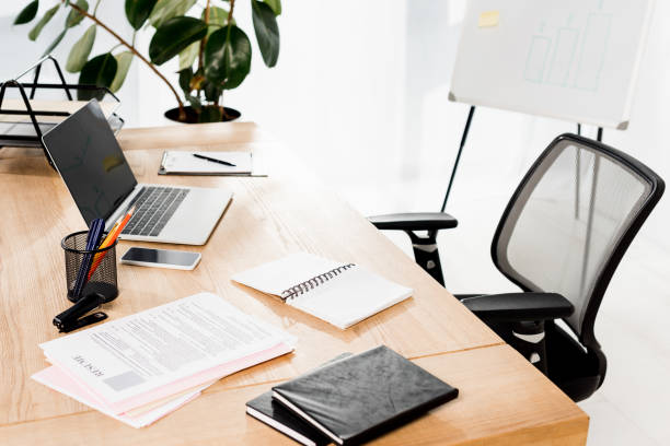 istock modern office with laptop, smartphone, resume and blank notebook on desk 1155163863