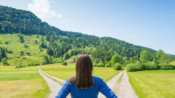 At the intersection of roads. The symbol is to make a choice. Female figure. Crossroad. The symbol is to make a choice. Female figure. crossroad stock pictures, royalty-free photos & images