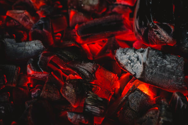 istock background with hot charcoal close up. 1155168168