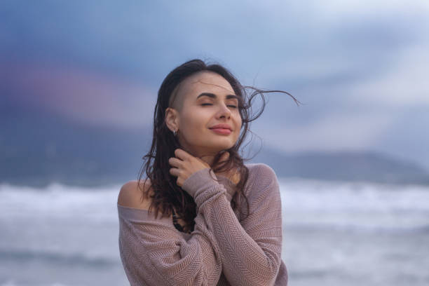 istock Young Woman at the Sea Coast Beach 1155169241