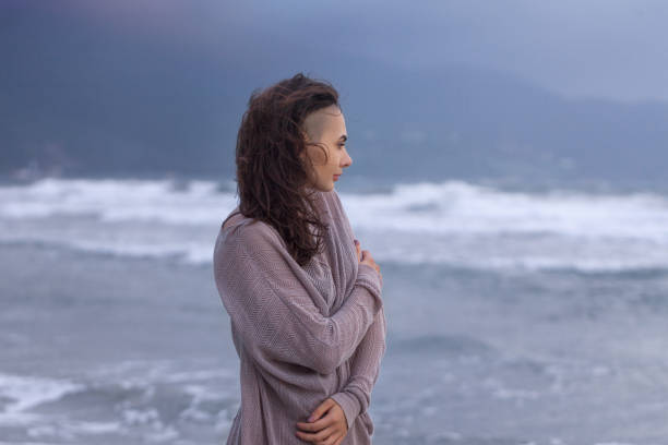 istock Young Woman at the Sea Coast Beach 1155169321