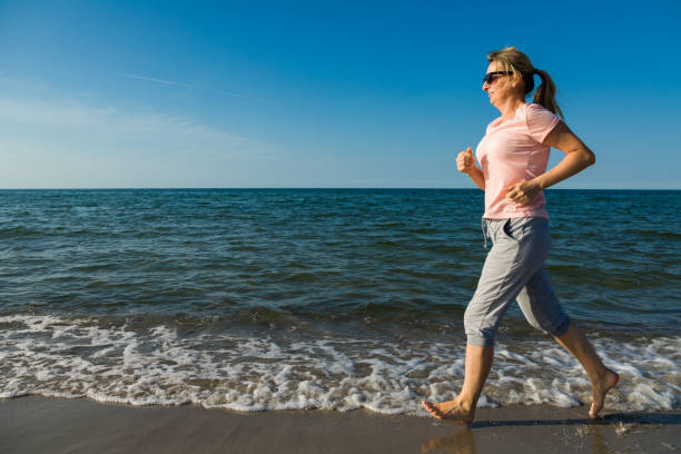 istock Woman running at seaside 1155170142