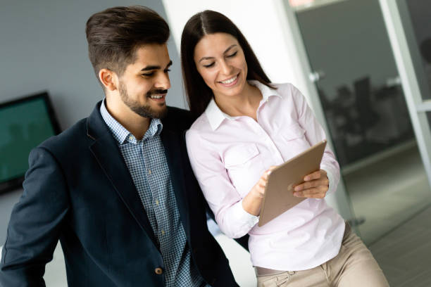 istock Confident business people reviewing project in office 1155172751