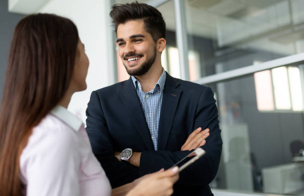 istock Confident business people reviewing project in office 1155172757