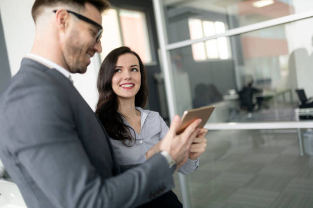 istock Confident business people reviewing project in office 1155172778