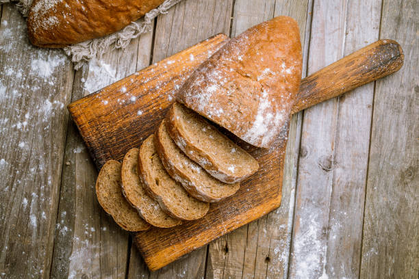 istock round black bread on wooden background 1155173945