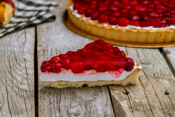 istock Cherry pie on wooden background 1155173978