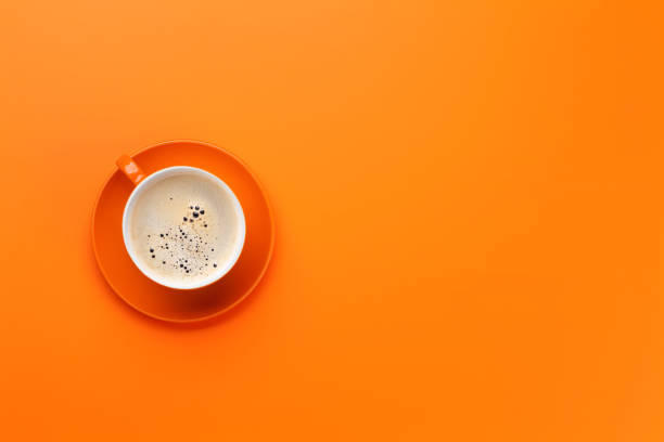 istock Orange coffee cup over orange background 1155174291