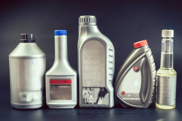 istock oil can bottles on black backgorund 1155174353