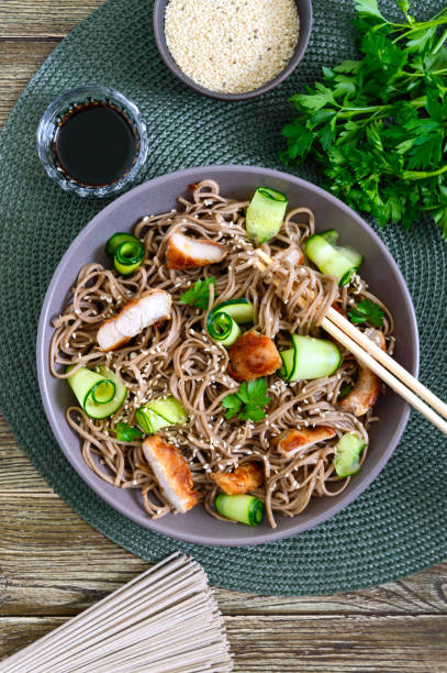 istock Cold soba with chicken, fresh cucumbers, sauce and sesame. Classic cold salad with buckwheat noodles. Japanese food. Traditional asian cuisine. Top view, flat lay. 1155174359