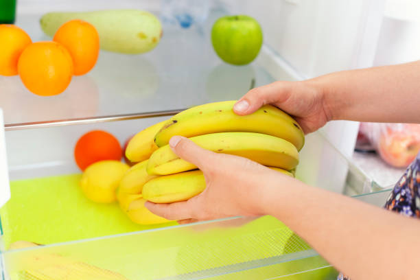istock Woman getting bananas from fridge 1155175760