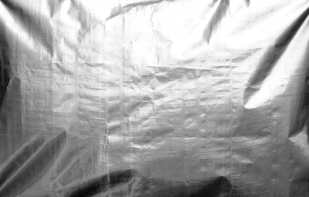 istock Metalized plasrtic wrap texture with crumples in black and white. 1155175789