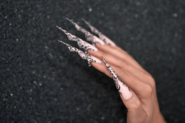 fashion model hand on gray background with long nails, glamour manicure.