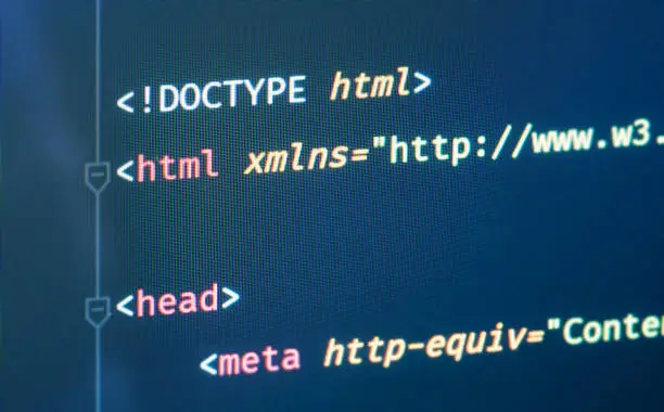 Photo of Html document code in text editor close-up on the screen