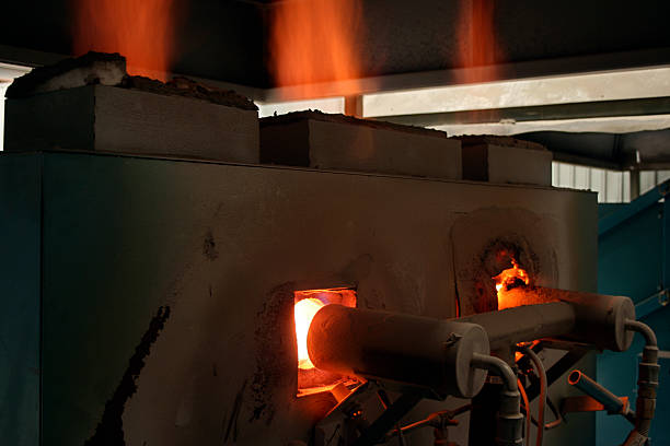 A ceramic lined industrial kiln shown from the back so you can see the gas burners. Kilns are used for burning, baking, firing pottery or melting metal.