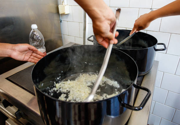 istock Stirring onions while frying in a pot 1155179352