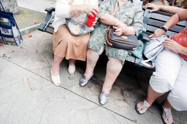 Gray haired senior woman in her late sixties is posing on the street with a cool hairstyle. The image has space for copy.