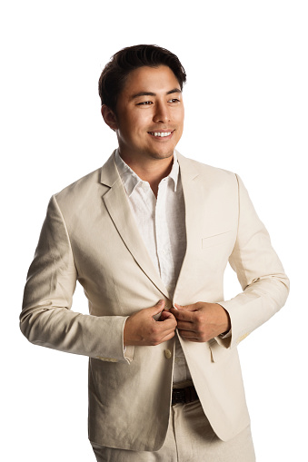 Handsome businessman wearing light colored suit, feeling calm and relaxed smiling. White background.