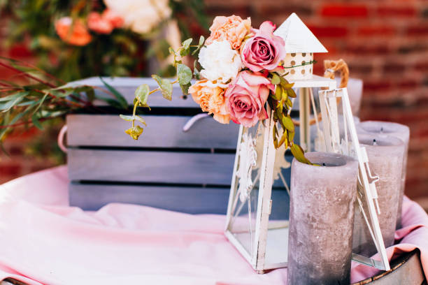 istock White lantern and black candles stand before blue wooden box 1155180350