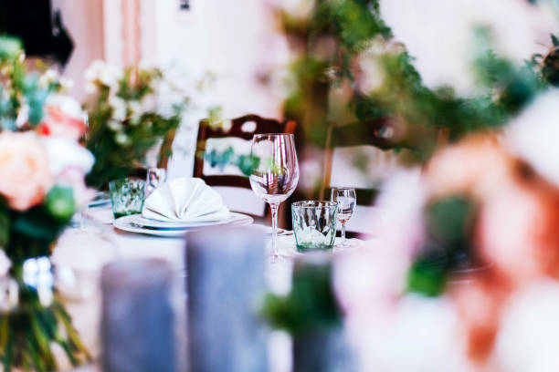istock Look over the bouquet at crystal glasses on the dinner table 1155180525