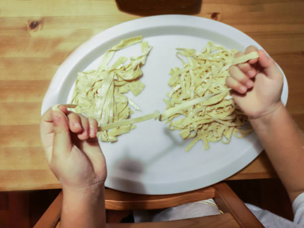 istock Preparing home made noodle by hands with personal perspective 1155181099