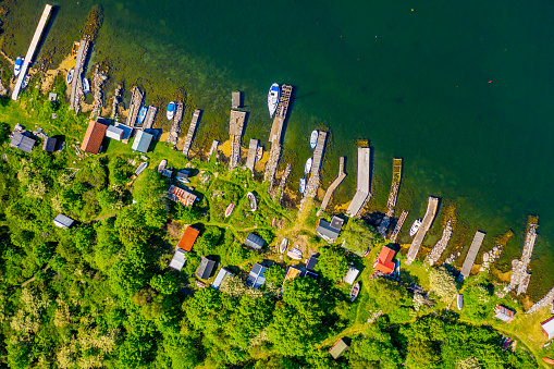 Straight down aerial of landscape full of small jetties, sheds and boats. Location Hasslo island in Blekinge archipelago, Sweden.