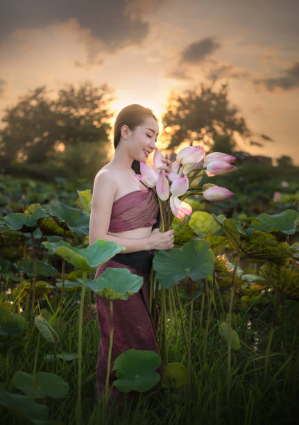 istock woman harvesting water lilies 1155181940