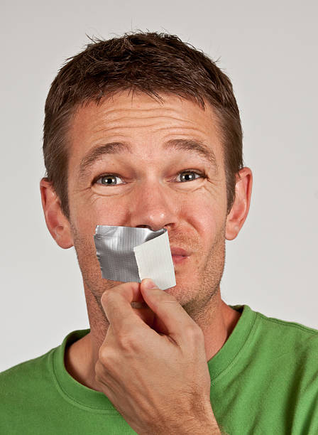 sprechen sie - human mouth duct tape covering adhesive tape stock-fotos und bilder