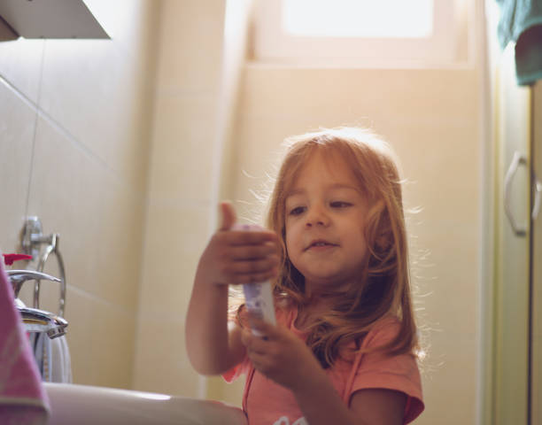 istock Little girl brushing her teeth 1155182499