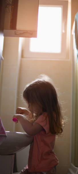 istock Little girl brushing her teeth 1155182687