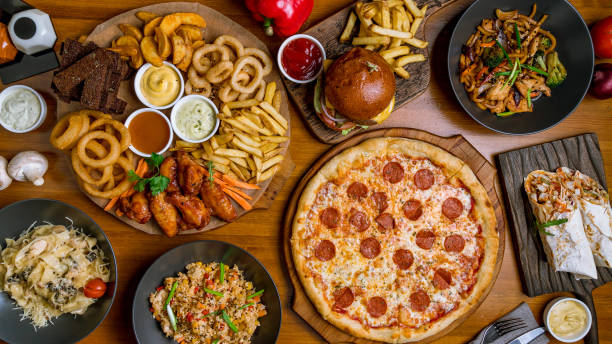 assorted beer snacks Assorted set from pizza Pepperoni, Assorted beer snacks, burger, wok and rice top view pub table top view stock pictures, royalty-free photos & images