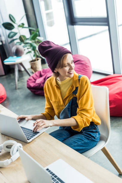 istock selective focus of beautiful young female it specialist using laptop in loft office 1155183769