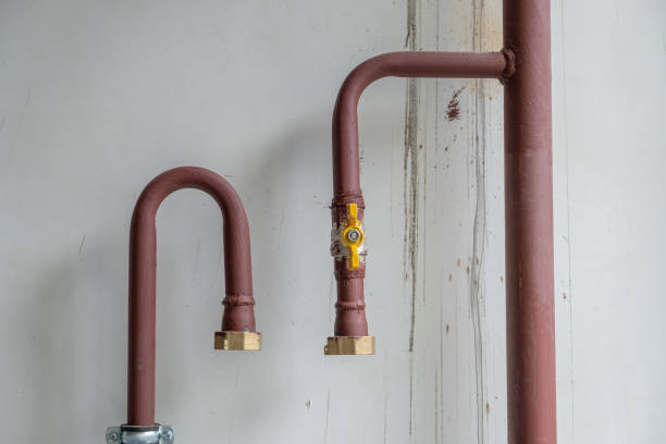 istock Heating system's cooper pipes with ball valves on a wall 1155183991