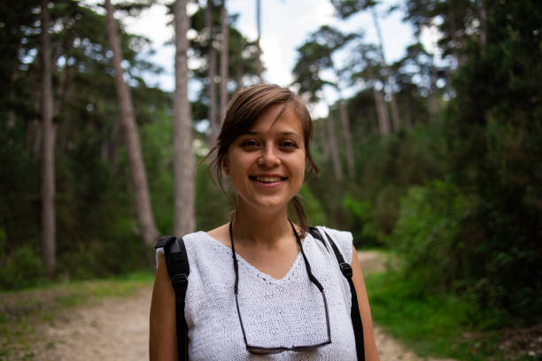 istock Portrait of a smiling woman explorer wearing a backpack 1155184021