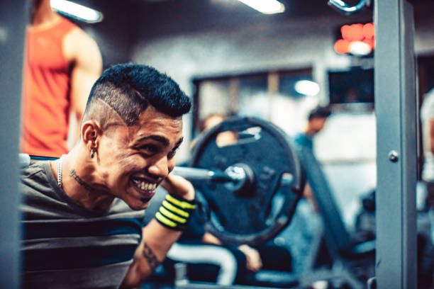 India, Fitness, Healthy Lifestyle - Fitness fanatic working out at a gym with his personal instructor