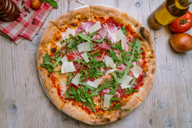 Pizza with Parma ham and arugula Pizza with Parma ham and arugula prosciutto stock pictures, royalty-free photos & images