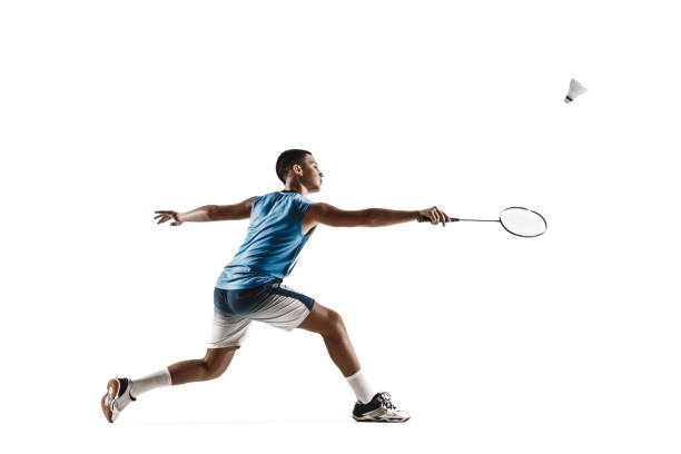 istock Little boy playing badminton isolated on white studio background 1155184850