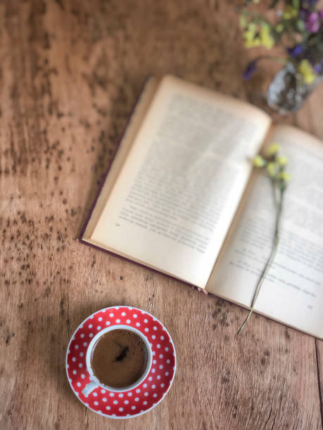 istock an old book and cup of coffee on wooden table 1155185265