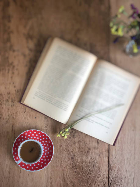 istock an old book and cup of coffee on wooden table 1155185268