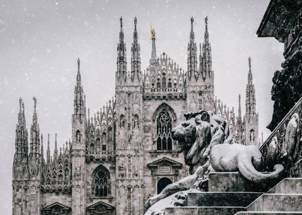 Snow falling at Piazza del Duomo in Milan, Lombardy, Italy with Milan's landmark Cathedral in background stock photo