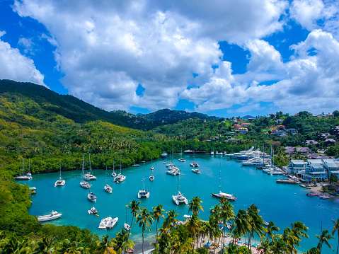 Stills shot from Drone of the beautiful Marigot bay detailing detailing boats, blue skies, fluffy clouds and Caribbean Sea.