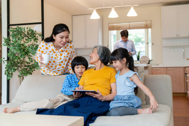 istock Multi-generation family looking at a digital tablet together 1155188262