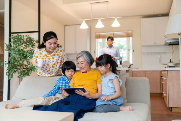 Multi-generation family looking at a digital tablet together