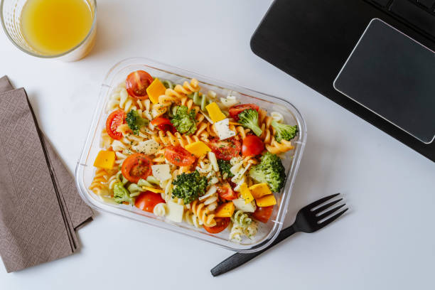istock Healthy food in lunch box, on working table with laptop 1155190597