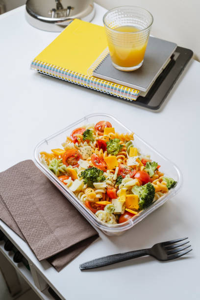 istock Healthy food in lunch box, on working table with laptop 1155190620