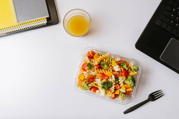 istock Healthy food in lunch box, on working table with laptop 1155190630