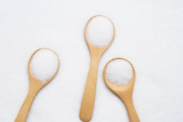 istock Wooden spoon with white granulated sugar. 1155190648