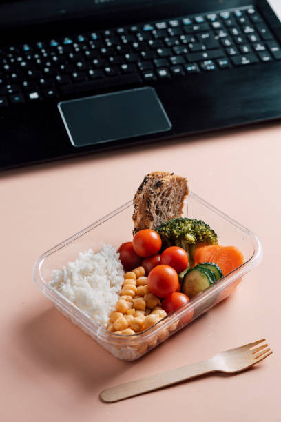 istock Healthy food in lunch box, on working table with laptop 1155190700