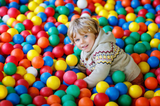 istock Little kid boy playing at colorful plastic balls playground 1155190896