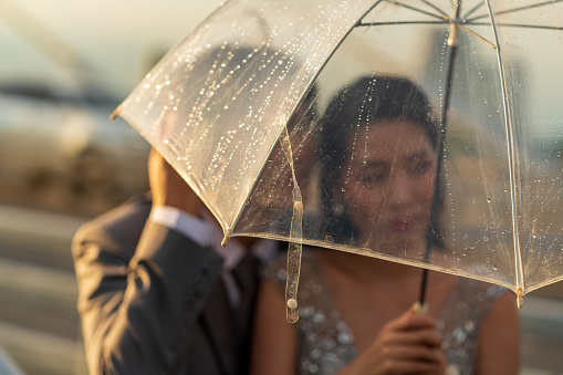 Silhouette couple prewedding under umbrella at sunset